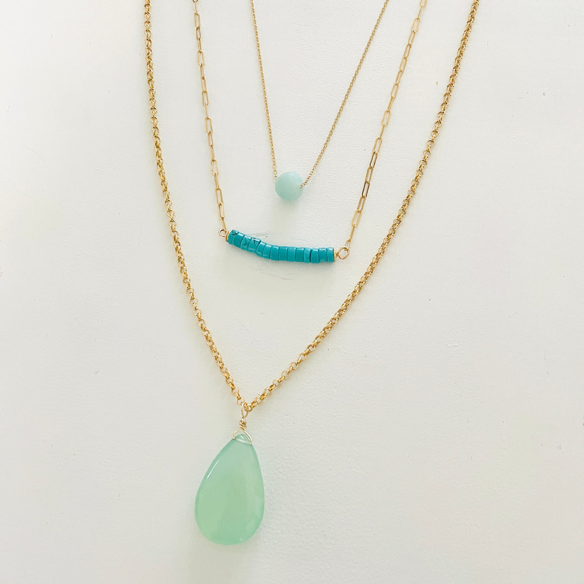 Turquoise & Gold Necklace trio by ZEN by Karen Moore close up on white background