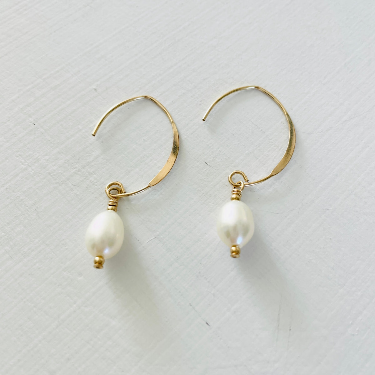 Classy Crescent Pearl  Earrings by ZEN by Karen Moore Jewelry gold angled view on white background