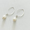 Classy Crescent Pearl  Earrings by ZEN by Karen Moore Jewelry silver angled view on white background
