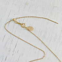 The Jenny Blues Amazonite Necklace by ZEN by Karen Moore on white wood showing close up of adjustable chain