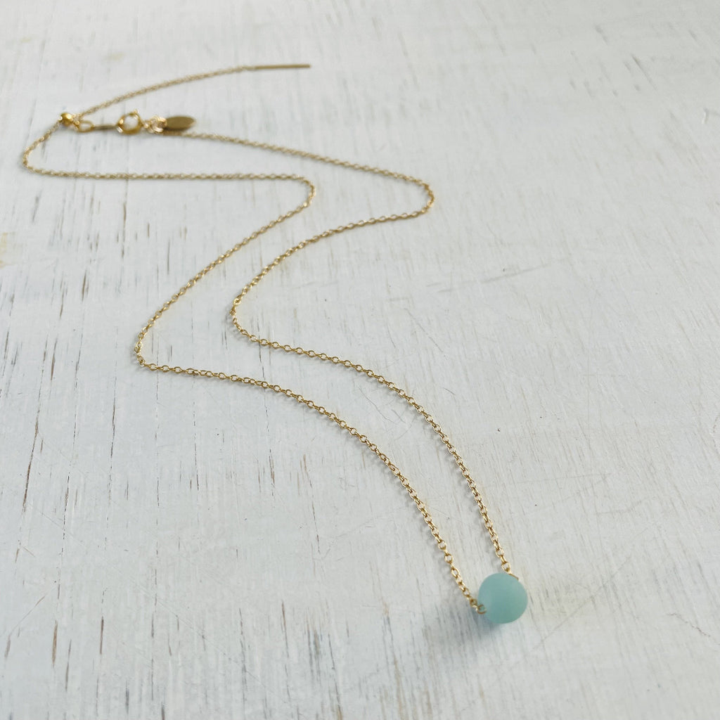 The Jenny Blues Amazonite Necklace by ZEN by Karen Moore on white wood showing full chain