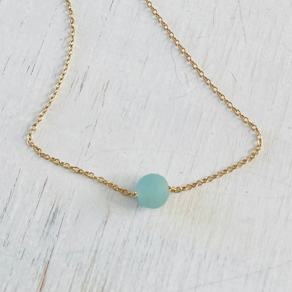 The Jenny Blues Amazonite Necklace by ZEN by Karen Moore on white wood showing blue stone