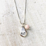 Just BE Free Charm Necklace by ZEN by Karen Moore Jewelry close up of charms on white wood