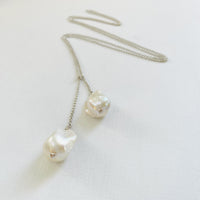 Wisdom Within ZEN Wrap Necklace by ZEN by Karen Moore Jewelry showing close up of pearls and chain zig-zagged on a white background