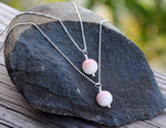 Two Simply Conch Shell Necklace with mini gem by ZEN by Karen Moore laying on a rock