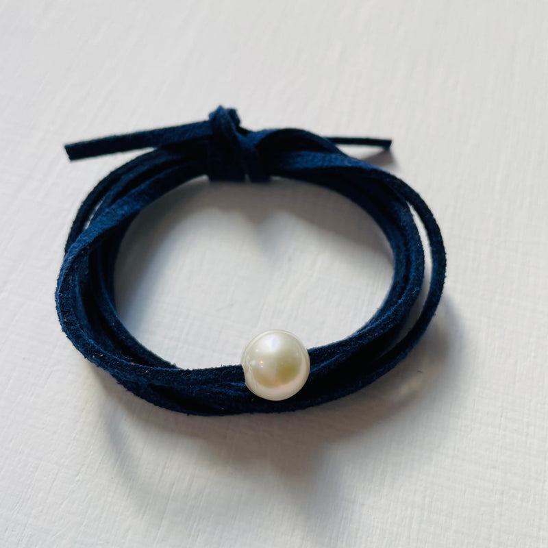 Pearl Of Wisdom Classy Navy Eco Zen Wrap Jewelry by ZEN by Karen Moore slightly angled on white wood