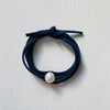 Pearl Of Wisdom Classy Navy Eco Zen Wrap Jewelry by ZEN by Karen Moore zoomed out on white wood