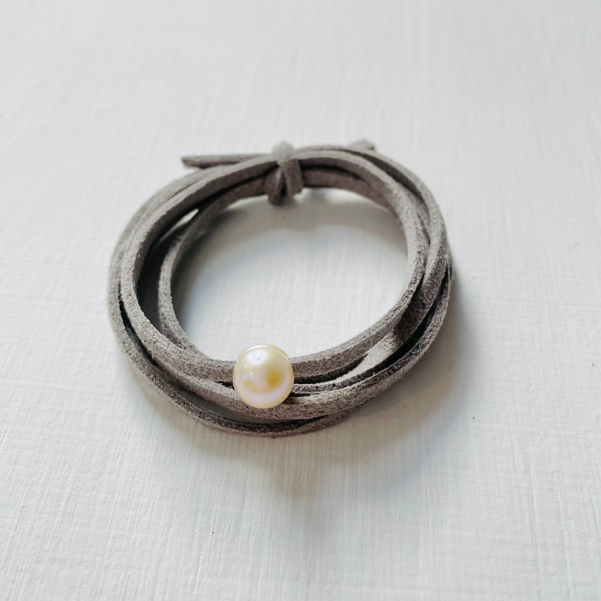 Pearl Of Wisdom Cool Stone Eco Zen Wrap Jewelry by ZEN by Karen Moore front view on white wood