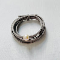 Pearl Of Wisdom Cool Stone Eco Zen Wrap Jewelry by ZEN by Karen Moore front view on white wood