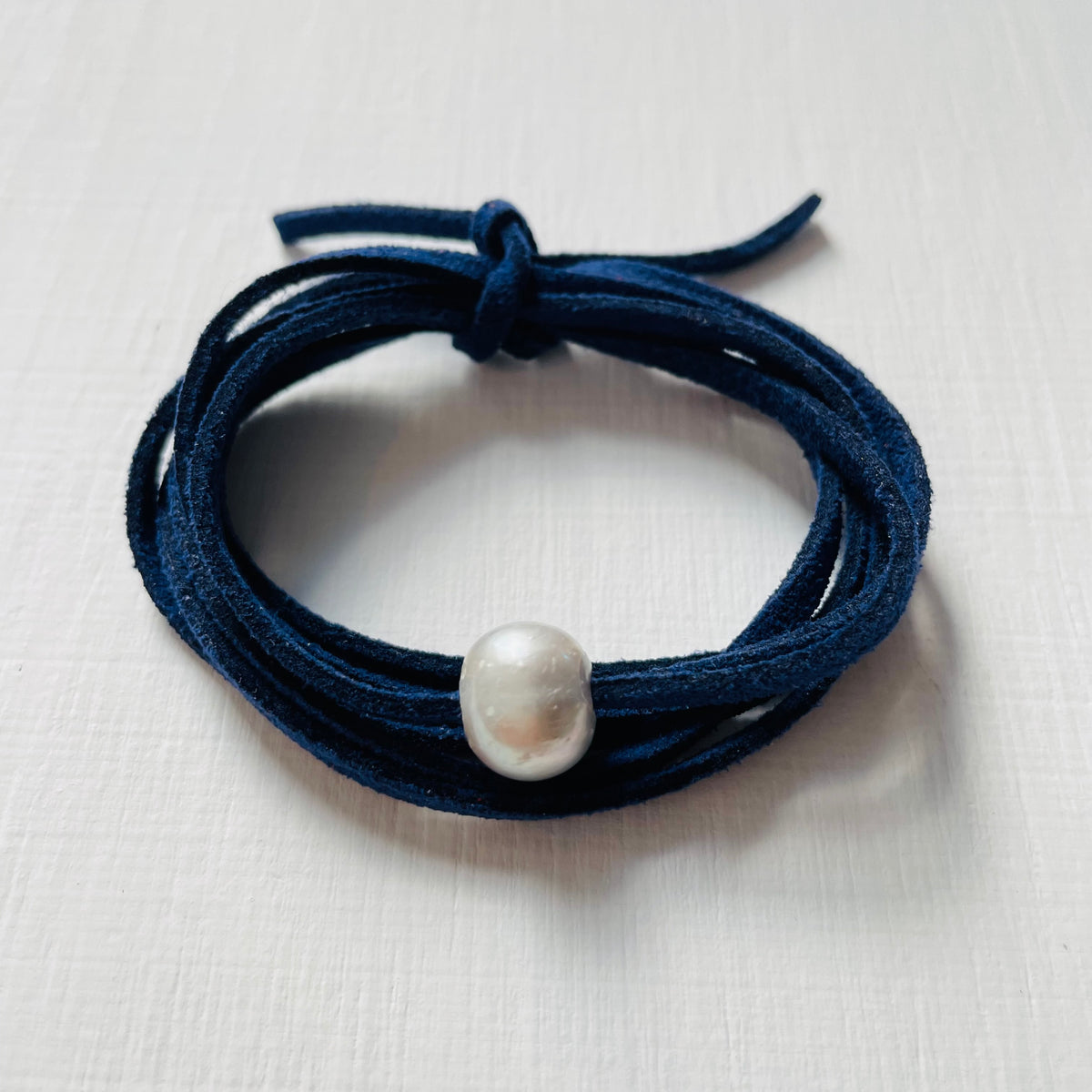 Pearl Of Wisdom Classy Navy Eco Zen Wrap Jewelry by ZEN by Karen Moore alt view on white wood