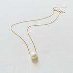 Floating Pearl Adjustable Necklace by ZEN by Karen Moore with gold chain on white background