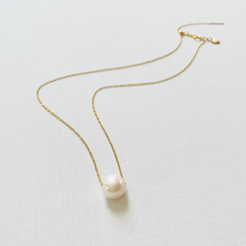 Floating Pearl Adjustable Necklace by ZEN by Karen Moore with gold chain on white background