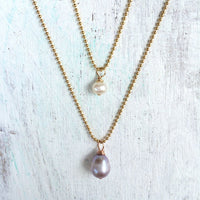 Simply Pearl-fect Necklace by ZEN by Karen Moore with one other necklace on white wood