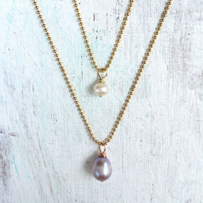 Simply Pearl-fect Necklace by ZEN by Karen Moore with one other necklace on white wood