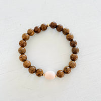 Mojo Conch Shell Tiger Wood Bracelet by ZEN by Karen Moore on white wood background