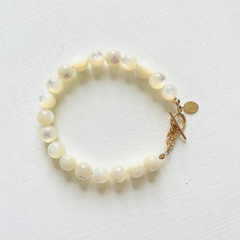 Nurtured by Nature Mother of Pearl Bracelet with 14K gold clasp by ZEN by Karen Moore jewelry overhead view on white background