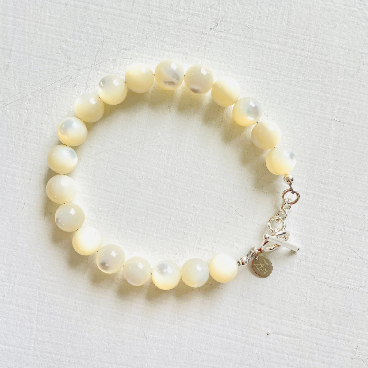 Nurtured by Nature Mother of Pearl Bracelet with sterling silver clasp by ZEN by Karen Moore jewelry overhead view on white background