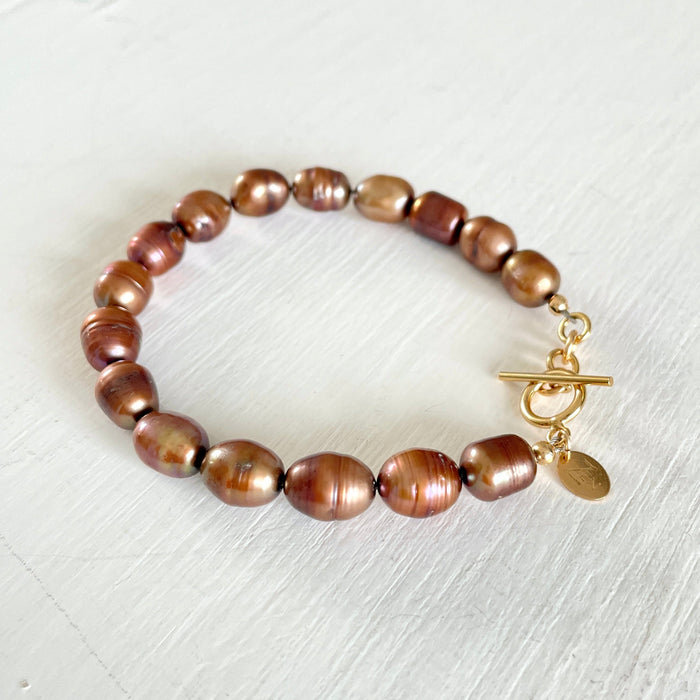 Bronze Pearl Bracelet by ZEN by Karen Moore jewelry with 14K gold clasp angled view on white background