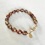 Bronze Pearl Bracelet by ZEN by Karen Moore jewelry with 14K gold clasp close up angled view on white background