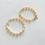 Just Peachy Pearl Bracelets, one with sterling silver clasp and one with 14K gold clasp by ZEN by Karen Moore Jewelry on white background