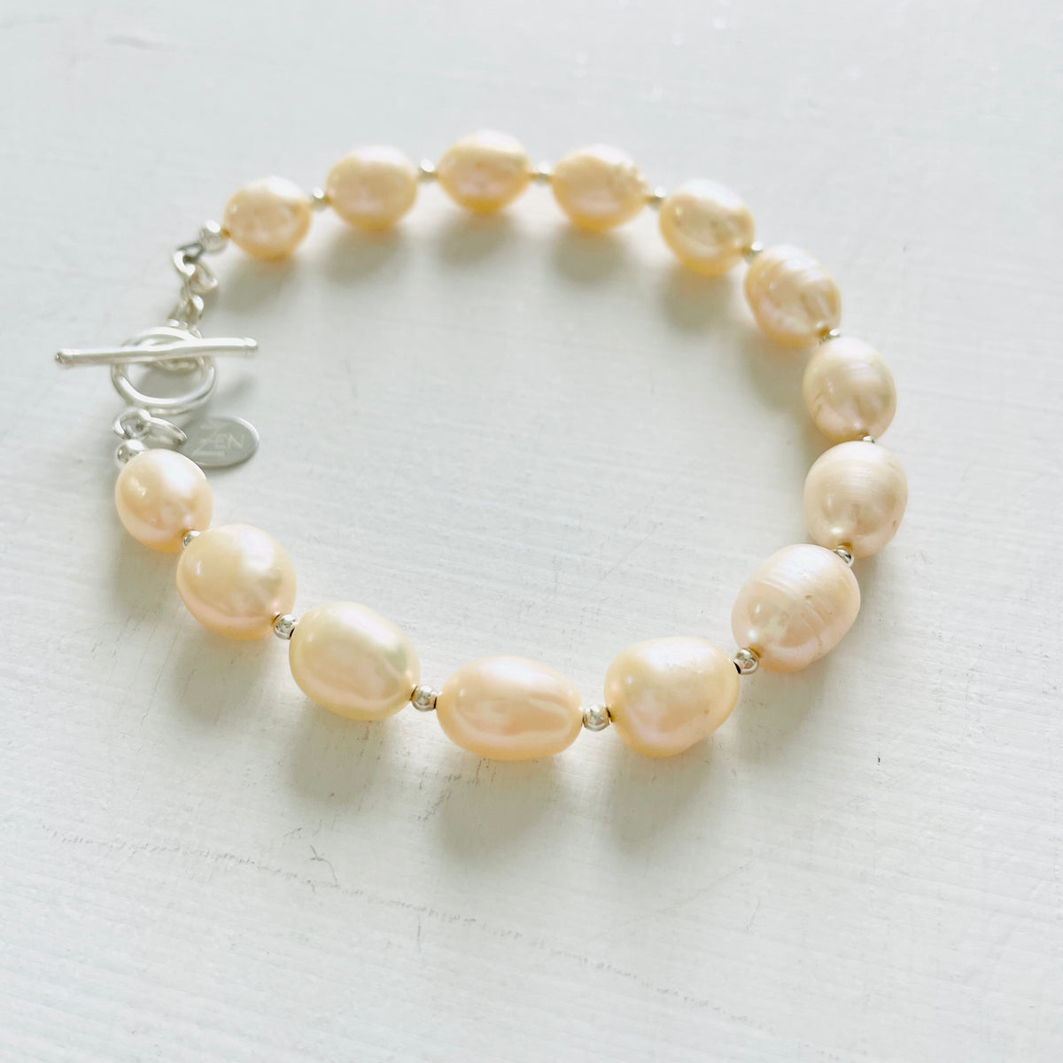 Just Peachy Pearl Bracelet with sterling silver clasp by ZEN by Karen Moore Jewelry close up on white background