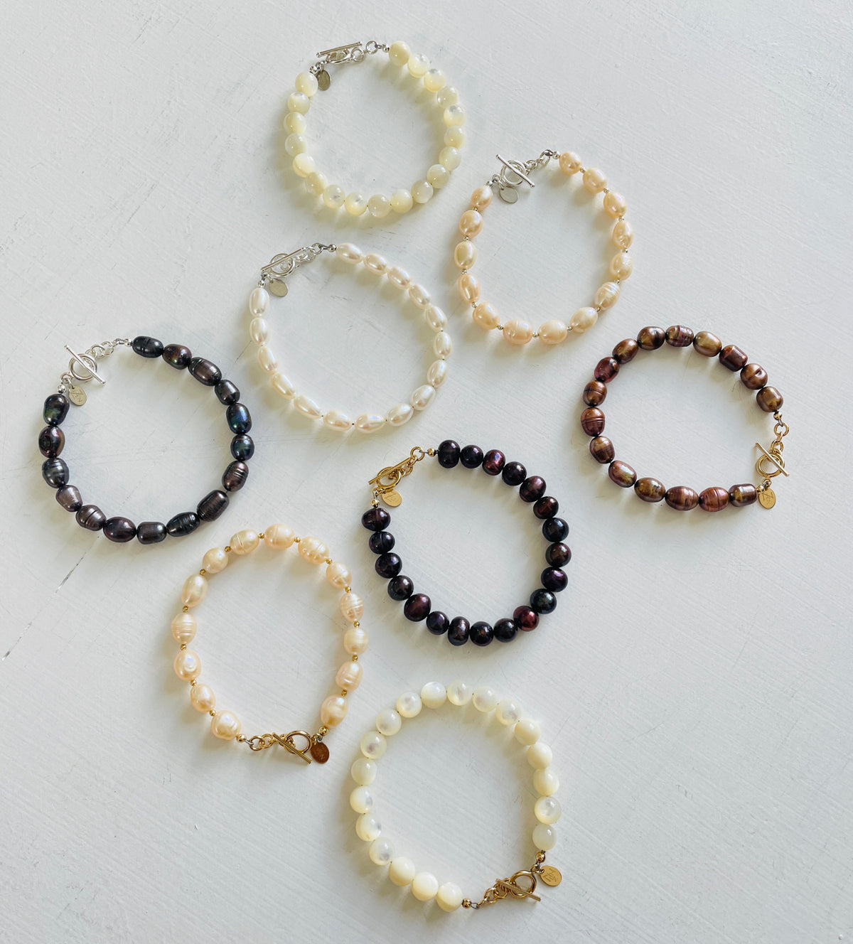 group of Mother of Pearl Bracelets by ZEN by Karen Moore jewelry overhead view on white background