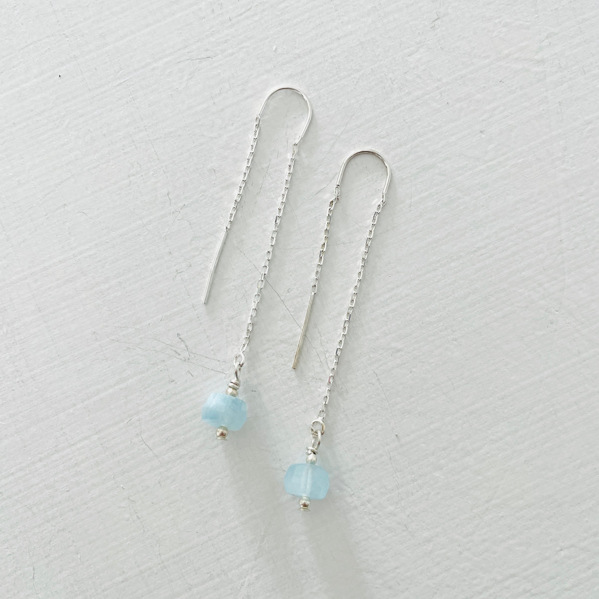 Drop into the Calm Aquamarine Earrings by ZEN by Karen Moore jewelry in sterling silver on white background