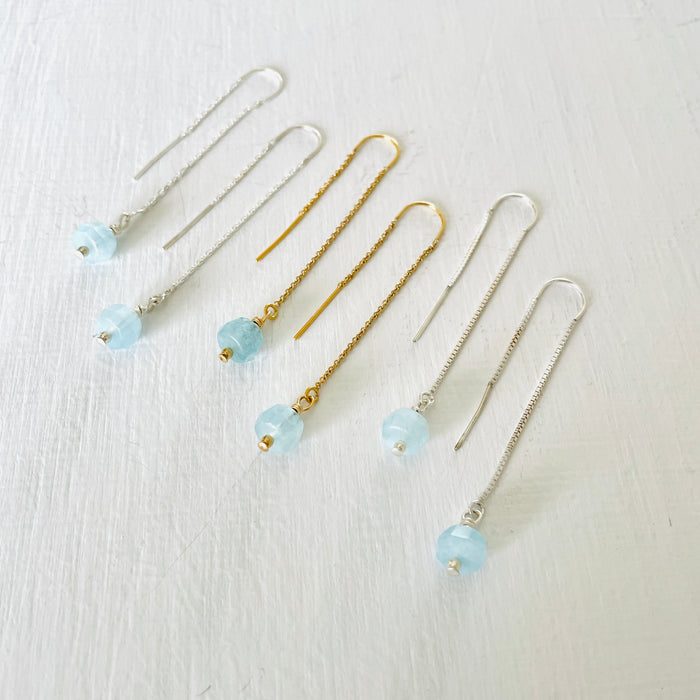 Drop into the Calm Aquamarine Earrings by ZEN by Karen Moore jewelry showing two pairs in sterling silver with a pair in 14K gold in the middle angled view on white background