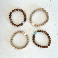 Mojo Sandalwood & Tiger Wood Bracelet group by ZEN by Karen Moore on white wood background