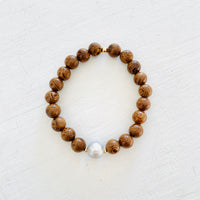Mojo Grey Pearl Tiger Wood Bracelet by ZEN by Karen Moore on white wood background