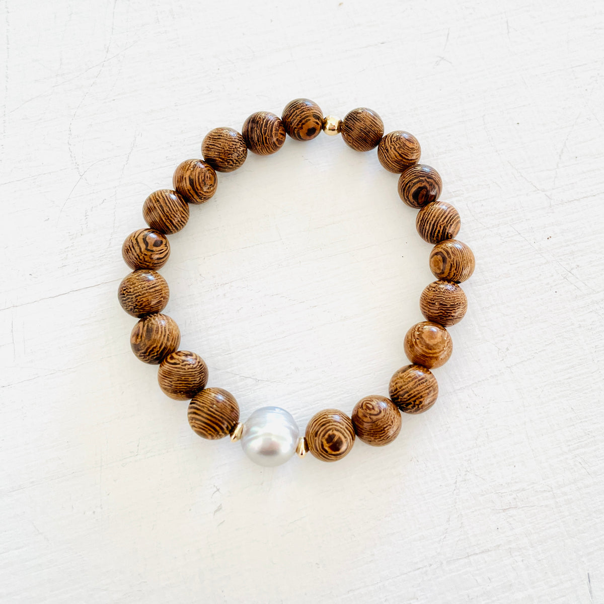 Mojo Grey Pearl Tiger Wood Bracelet by ZEN by Karen Moore on white wood background