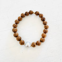 Mojo Grey Pearl Tiger Wood Bracelet by ZEN by Karen Moore on white wood background
