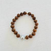 Mojo Grey Pearl Tiger Wood Bracelet by ZEN by Karen Moore on white wood background
