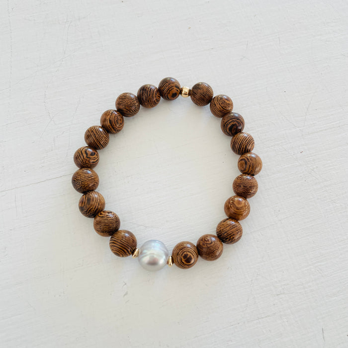 Mojo Grey Pearl Tiger Wood Bracelet by ZEN by Karen Moore on white wood background