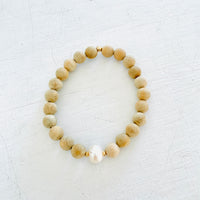 Mojo Freshwater Pearl Sandalwood Bracelet by ZEN by Karen Moore on white wood background