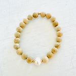 Mojo Freshwater Pearl Sandalwood Bracelet by ZEN by Karen Moore on white wood background