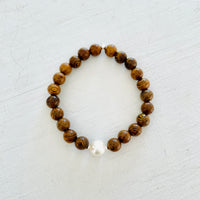 Mojo Freshwater Pearl Tiger Wood Bracelet by ZEN by Karen Moore on white wood background