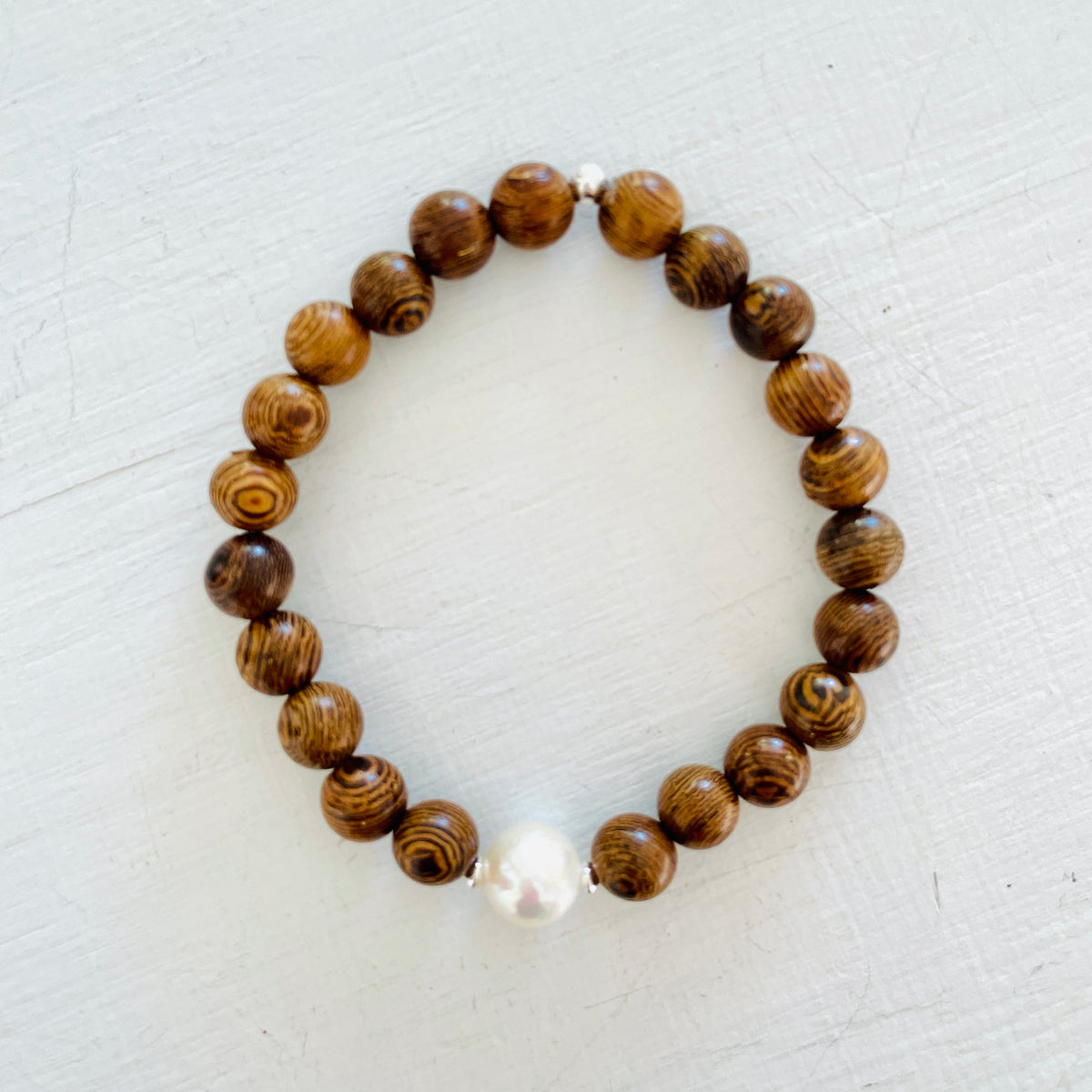 Mojo Freshwater Pearl Tiger Wood Bracelet by ZEN by Karen Moore on white wood background