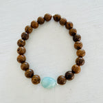 Mojo Amazonite Tiger Wood Bracelet by ZEN by Karen Moore close up on white wood background