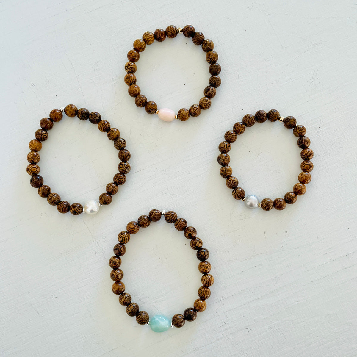 Mojo Tiger Wood Bracelet group by ZEN by Karen Moore on white wood background