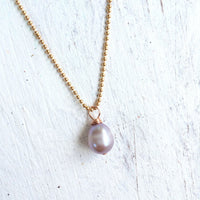 Island Love pearl necklace by ZEN by Karen Moore angled view on white wood