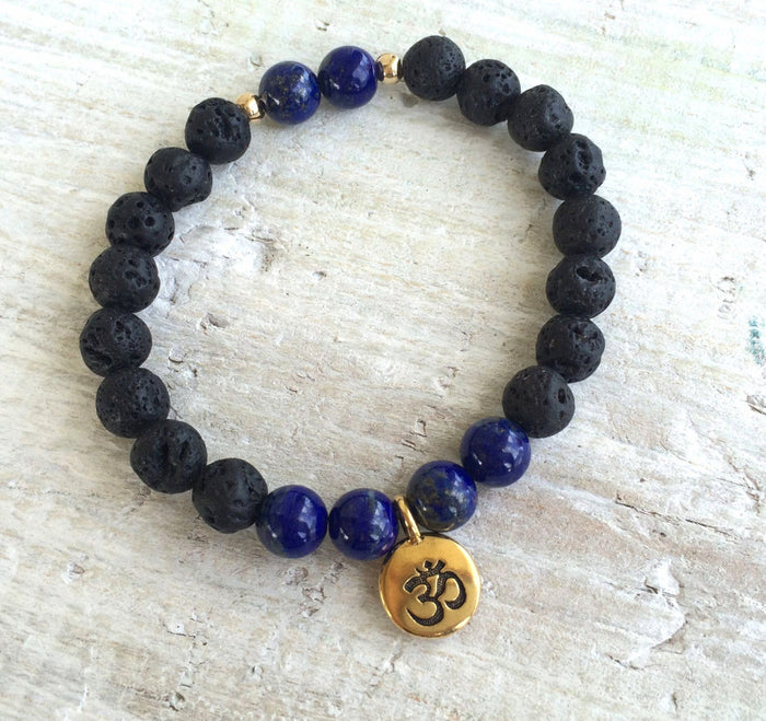 Lapis lazuli & lava stone OM Serenity Aromatherapy Bracelet by ZEN by Karen Moore on white wood