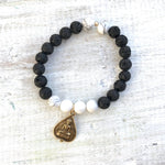 Howlite & lava stone Be A Blissful Buddha Aromatherapy Bracelet by ZEN by Karen Moore on white wood