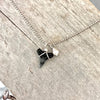 Sharmkie Charm pearl & shark tooth charm necklace by ZEN by Karen Moore on wood background