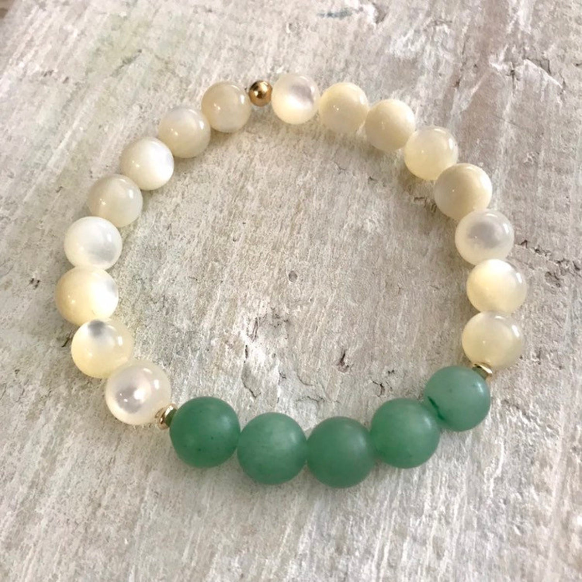 Live Well & Love aventurine & mother-of-pearl bracelet by ZEN by Karen Moore on white wood