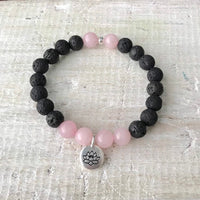 Rose quartz & lava stone Lotus Love Aromatherapy Bracelet by ZEN by Karen Moore on white wood
