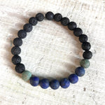 African turquoise, lapis lazuli & lava stone Take Good Care Aromatherapy Bracelet by ZEN by Karen Moore on white wood