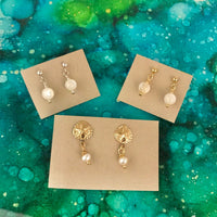 Pearl ZEN Mini Earrings by ZEN by Karen Moore set of three on blue/green splatter background