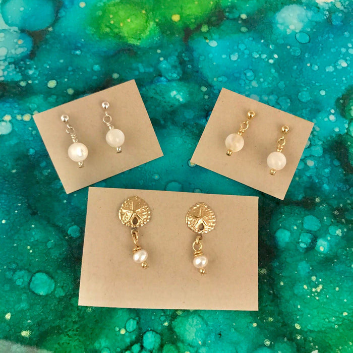 Pearl ZEN Mini Earrings by ZEN by Karen Moore set of three on blue/green splatter background