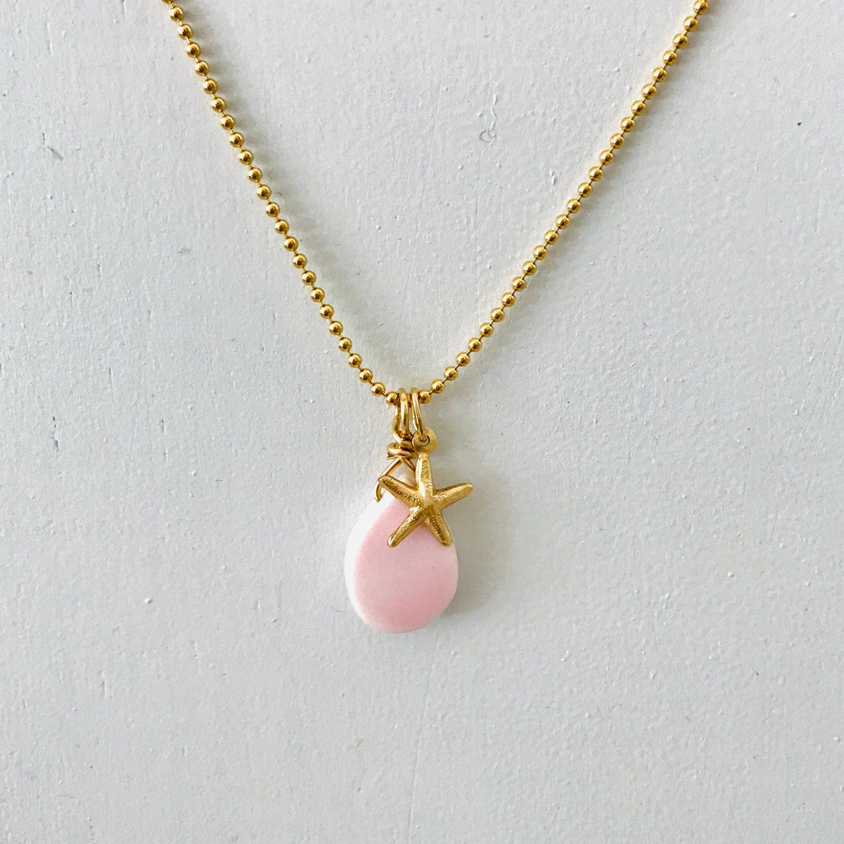 Starfish & Conch Shell Charm necklace by ZEN by Karen Moore on white background
